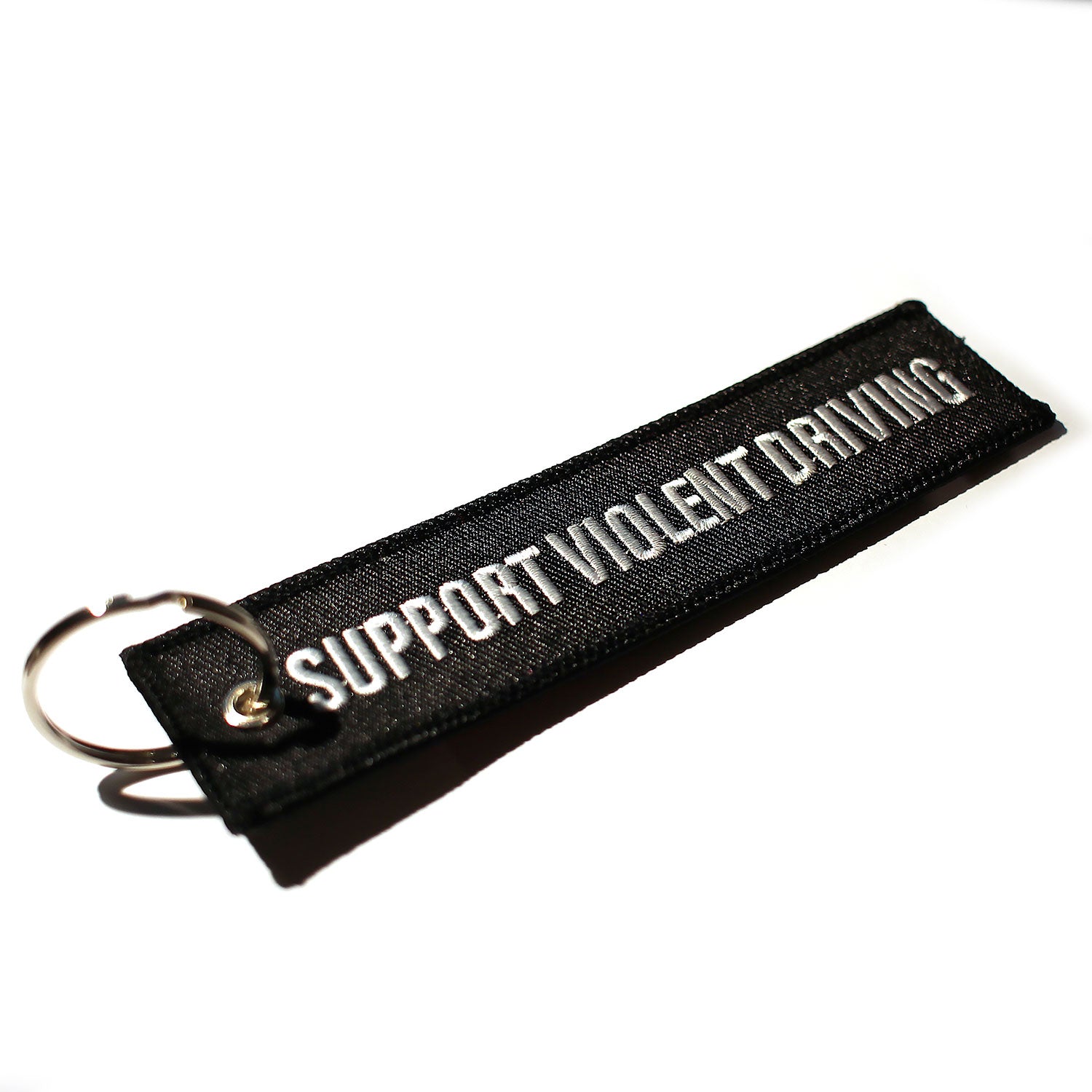 Black keychain with 'Support Violent Driving' text in White 