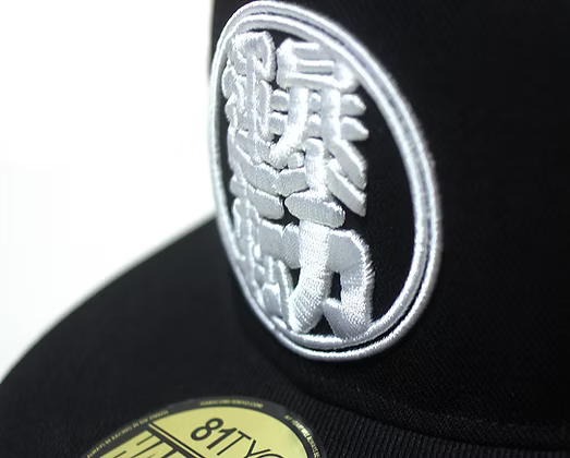 Black cap with a white embroidered logo on a white background
Happi Snapback
Hardcore Tokyo