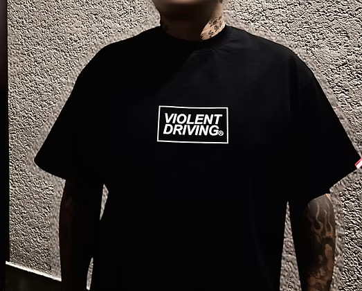 Hardcore Tokyo Hashtag Heavy T-shirt
Person wearing a black t-shirt with 'Violent Driving' text against a textured wall.